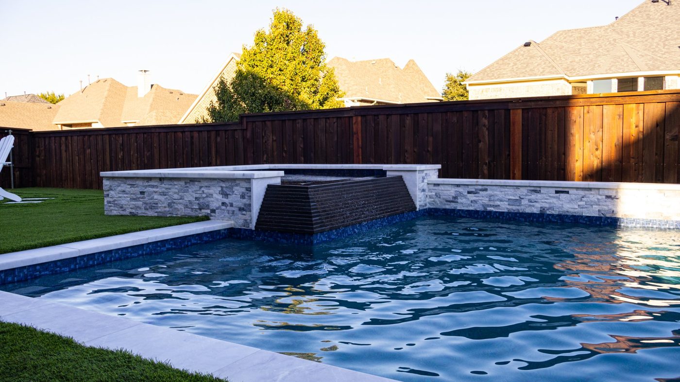 Custom geometric pool with spa and stone water feature — Dallas, TX