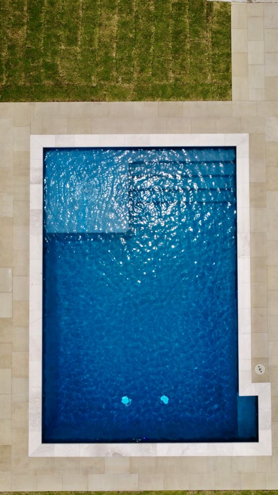 Aerial view of geometric custom pool with tanning ledge — Plano, McKinney TX
