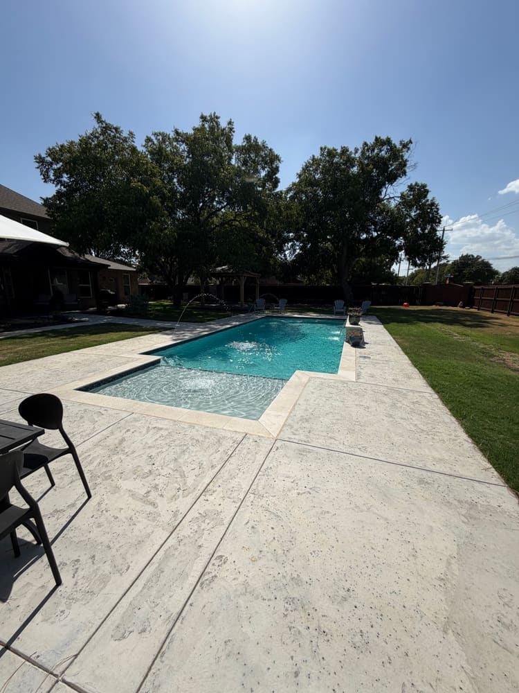 Sheer descent pool corner in evening light — LiquidLux Custom Pools